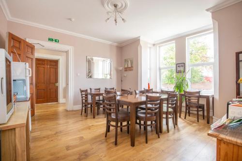 a kitchen and dining room with a table and chairs at Marlborough Hotel in Norwich