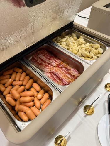 a refrigerator filled with trays of different types of food at Pava De Luxe in Berehove