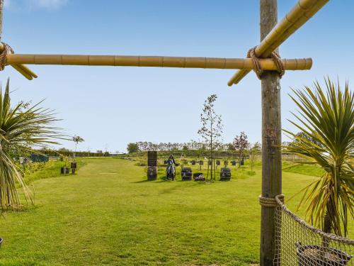 a view of a park with palm trees and a fence at Lodge 38 in Stonham Aspall
