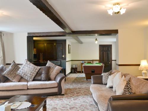 a living room with couches and a pool table at The Old School in Durham