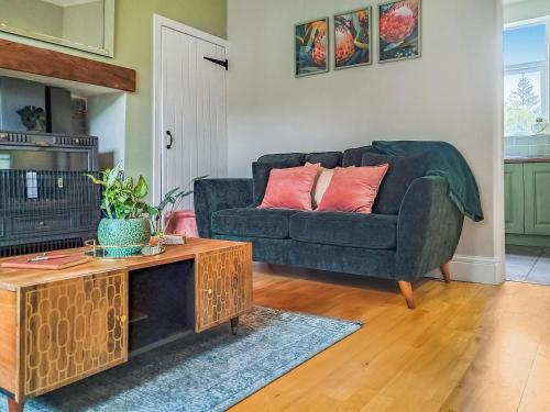 a living room with a couch and a table at Railway Cottage in Stanhope