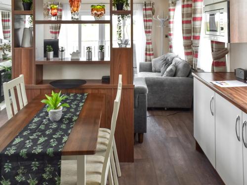 a kitchen and living room with a table and a couch at The View in Whitstable