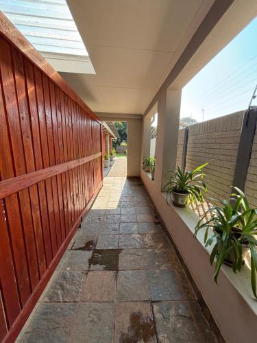 a hallway of a house with a fence and plants at 59 van Heerden in Mokopane