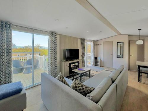 a living room with a couch and a television at Rosie's Retreat in Morpeth
