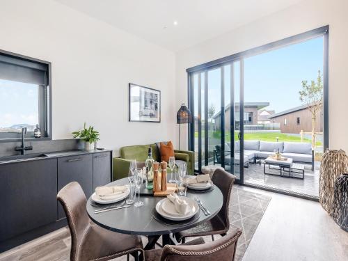 a dining room with a table and chairs at Lodge Six - Uk42798 in Llangefni