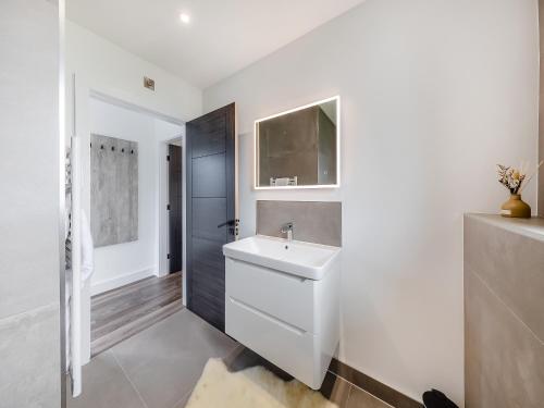 a white bathroom with a sink and a mirror at Lodge Six - Uk42798 in Llangefni