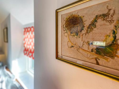 a picture of a painting of a sunflower on a wall at Ddwylig Bach - Uk48623 in St Asaph