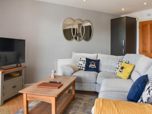 a living room with a couch and a table at Waterside Retreat in Carnforth
