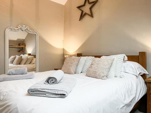 a bedroom with a white bed with a mirror at The Old Hayloft-Uk39431 in Dronfield