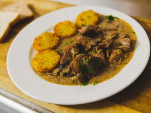 a white plate of food with meat and potatoes at ibis Styles Caen centre gare in Caen