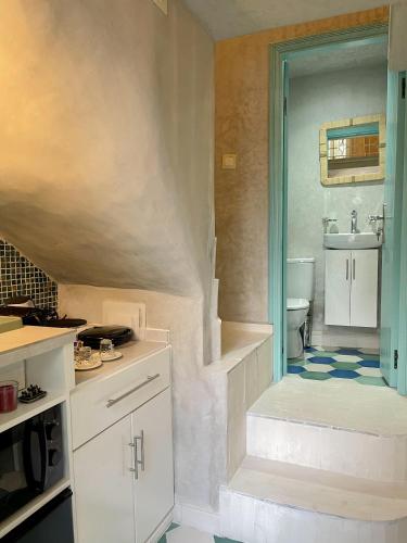 a bathroom with a toilet and a sink at Studio Turquesa Kasbah Tangier in Tangier
