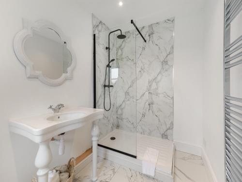 a white bathroom with a sink and a shower at The Farmhouse - Uk45171 in Southwell
