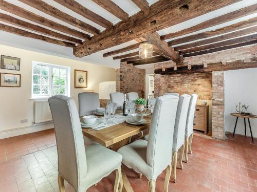 a dining room with a wooden table and chairs at The Farmhouse - Uk45171 in Southwell