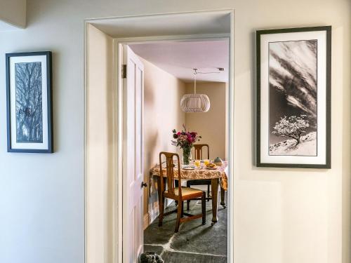 a hallway leading to a dining room with a table at Hollyhock in Tavistock