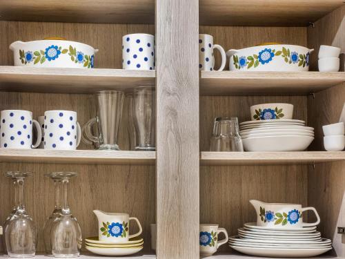 a shelf full of cups and plates and bowls at Hollyhock in Tavistock