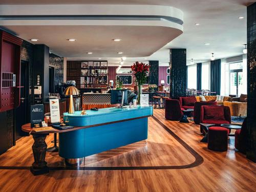 a salon with a blue counter and chairs at ibis Styles Wałbrzych in Wałbrzych