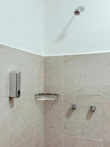 a shower in a bathroom with a white ceiling at Casa Monarca in Oaxaca City