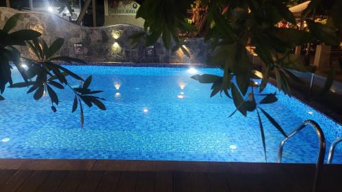a swimming pool at night with lights on it at Casa Tartaruga in Unawatuna