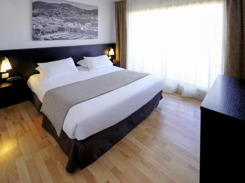 Ένα ή περισσότερα κρεβάτια σε δωμάτιο στο Aparthotel Adagio Nice Promenade des Anglais