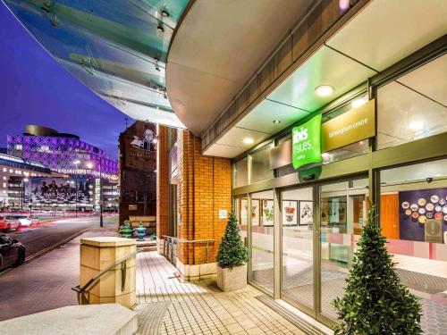 a store front of a building with christmas trees outside at ibis Styles Birmingham Centre in Birmingham