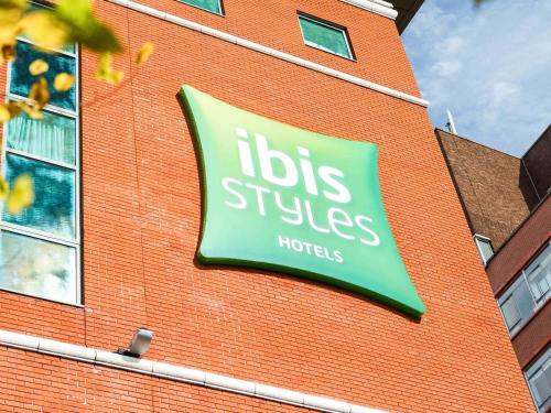 a sign on the side of a brick building at ibis Styles Birmingham Centre in Birmingham