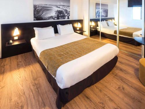 Ένα ή περισσότερα κρεβάτια σε δωμάτιο στο Aparthotel Adagio Nice Promenade des Anglais