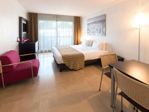 Ένα ή περισσότερα κρεβάτια σε δωμάτιο στο Aparthotel Adagio Nice Promenade des Anglais
