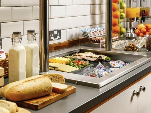 a buffet line with bread and bottles of milk at ibis Styles Birmingham Centre in Birmingham