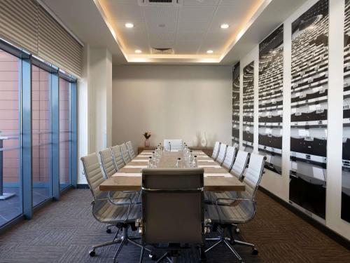 a conference room with a long table and chairs at ibis Ankara Airport Hotel in Ankara