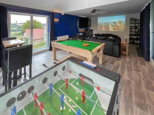 a living room with a pool table at The Farmhouse, Ley Farm in Yarcombe