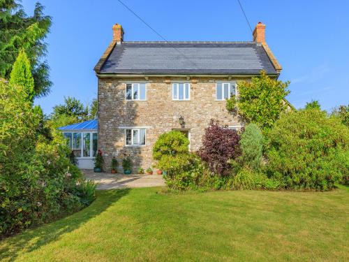 an old brick house with a lawn in front of it at The Farmhouse, Ley Farm in Yarcombe