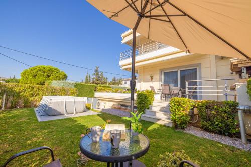 a patio with a table and an umbrella at Santa Barbara Garden and Pool Home in Marathón