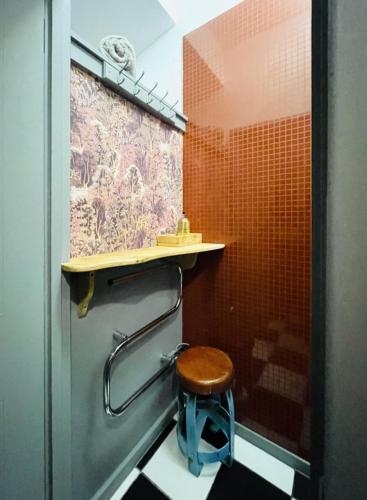 a bathroom with a toilet with a stool under a counter at Daiches Braes Brunstane Portobello in Edinburgh