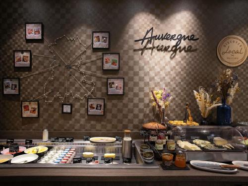 a buffet line with many different types of food at Mercure Clermont Ferrand centre Jaude in Clermont-Ferrand