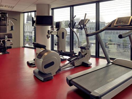 a gym with a treadmill and elliptical machines at Mercure Clermont Ferrand centre Jaude in Clermont-Ferrand