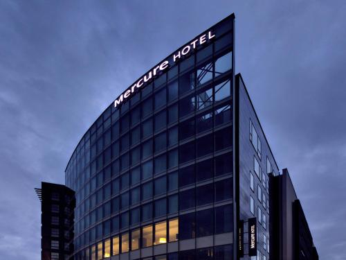 a building with a sign on the top of it at Mercure Clermont Ferrand centre Jaude in Clermont-Ferrand