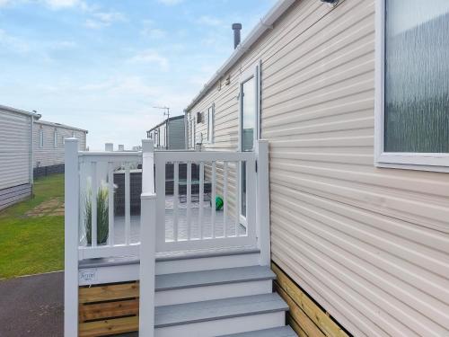 a balcony with a gate on a house at Marni's Seaview in Heysham