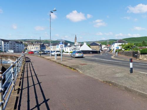 a street with a car parked on the road at Lena's Corner in Dunoon