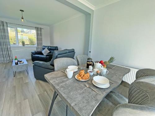 a living room with a table with food on it at Driftwood Cottage in Portpatrick