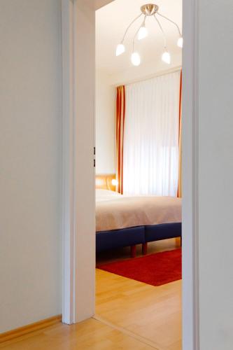 a bedroom with a bed and a window at Hotel Trierer Hof in Koblenz