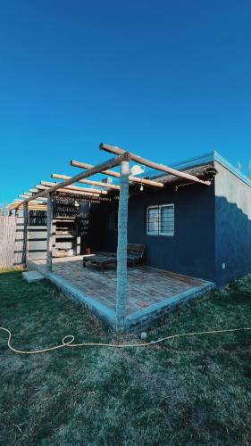 a house with a roof with a picnic table in the yard at Ciruelos del Sur - San Rafael Mendoza in San Rafael