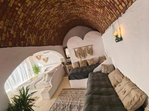 a living room with two beds and a couch at Nala Narty Boutique Hotel & Farm in Aswan
