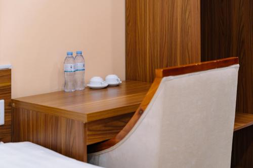 a room with two bottles of water on a wooden desk at Ha Giang City Hotel in Ha Giang