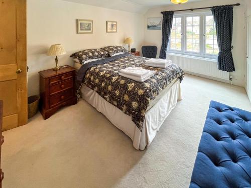 a bedroom with a bed and a dresser and a window at Green Trees in Maidstone