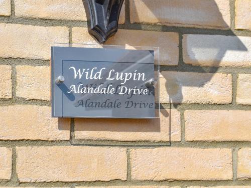 a sign on the side of a brick wall at Wild Lupin in Kessingland
