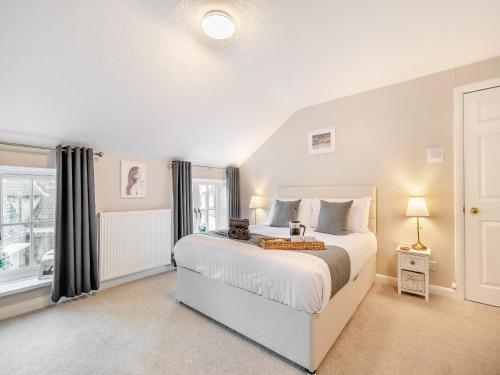 a bedroom with a large bed and a window at Forge House in Thornton Dale