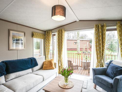 a living room with a couch and a table at Marlow Lodge in Hyssington