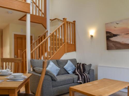 a living room with a couch and a table at Sandpiper in Carnforth