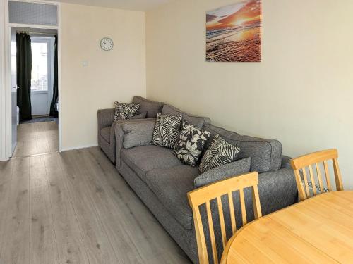 a living room with a couch and a table at Bonnieville in Hunstanton