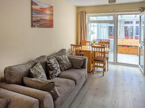 a living room with a couch and a table at Bonnieville in Hunstanton